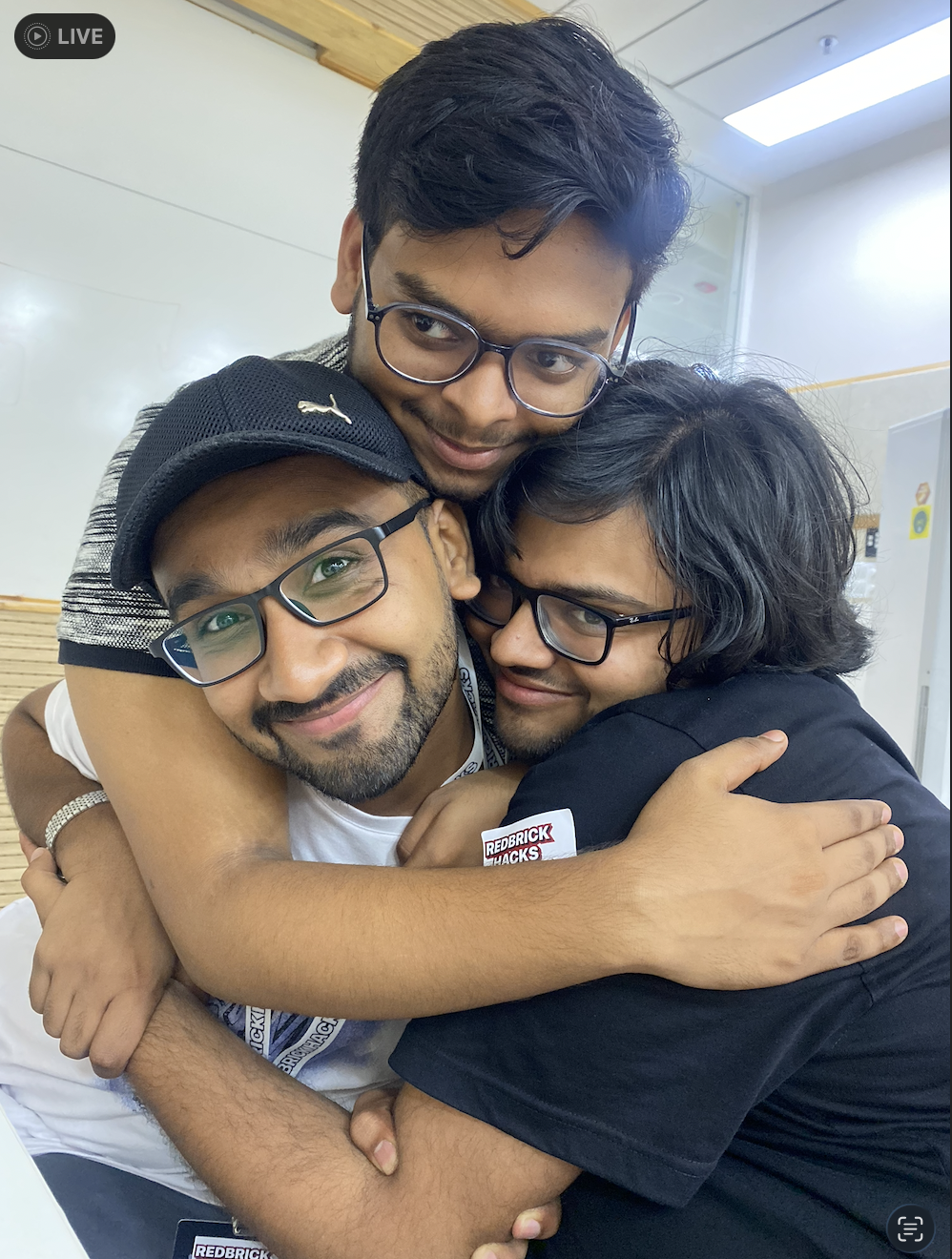 Kumar sharing a cheerful group hug with friends